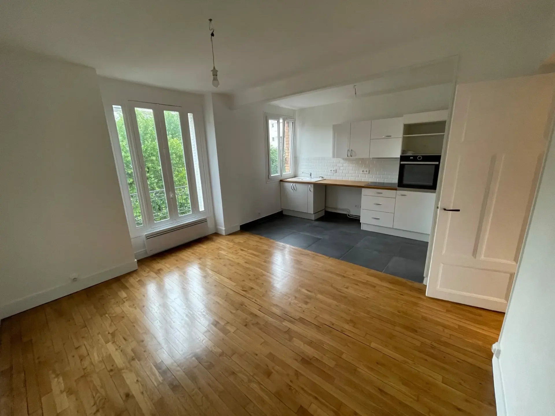 Séjour d'appartement ancien rénové par UMPT avec parquet et cuisine ouverte